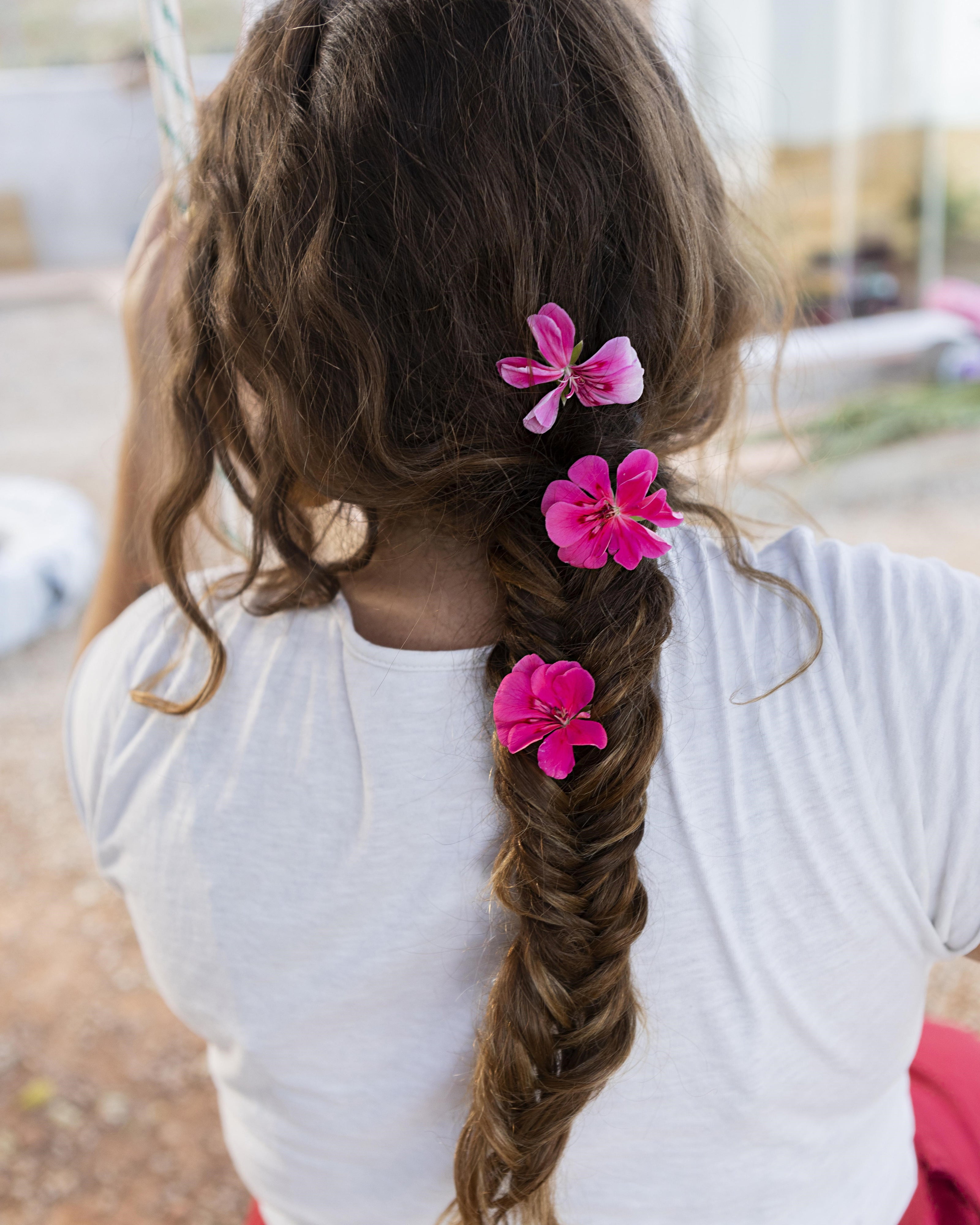 Woman using French Braider Machine to style trendy Viking braids effortlessly.